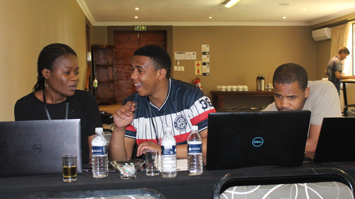 Group of 3 people in South Africa at a Space Apps event in front of computers
