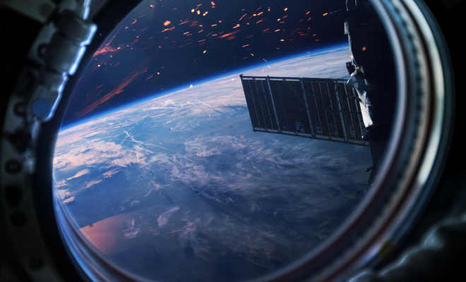 Artist rendition of a window view of Earth from a spaceship. The view shows Earth and parts of a spaceship with sparks.