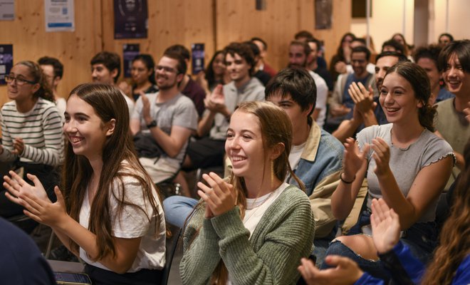 Group image of a crowd clapping hands