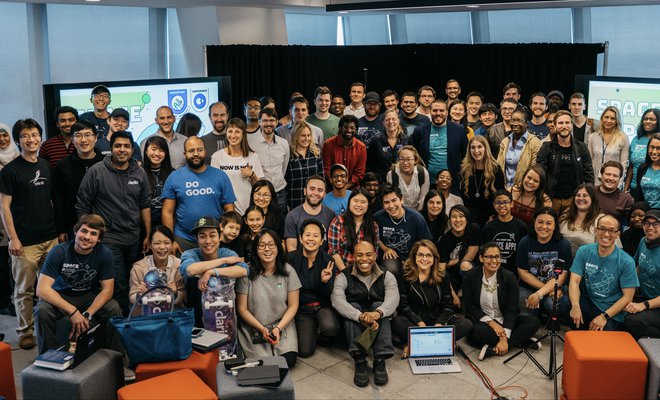 Large group of diverse people of ages in frame for a group picture at a Space Apps event