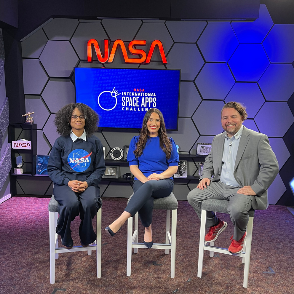 Denise Hill, Marie Mimiaga, Keith Gaddis sitting side by side at the NASA Goddard studio